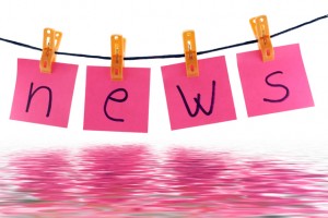 pink post it notes clothespinned to a line spelling out news