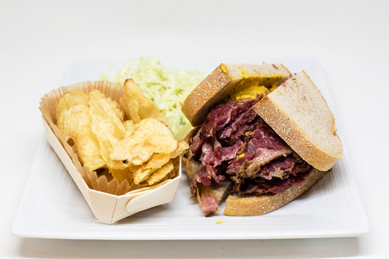 smoked meat sandwich and potato chips