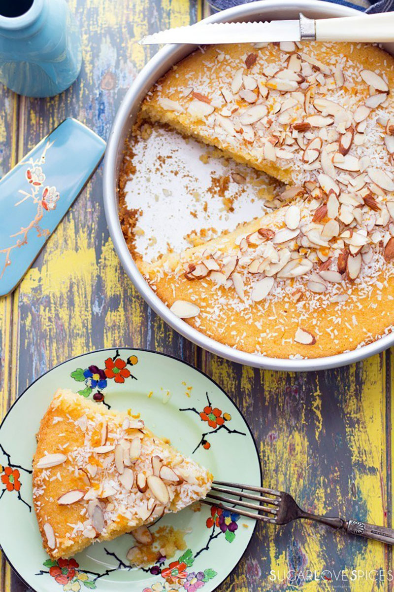 A slice of semolina cake soaked in orange blossom syrup removed from the whole cake