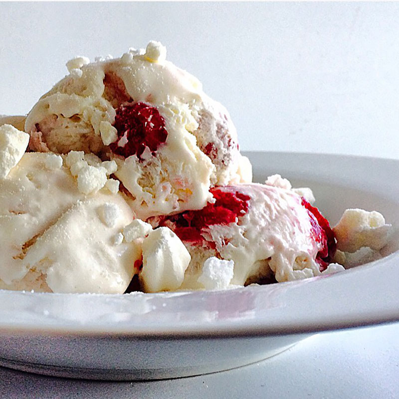 A bowl full of raspberry rose ice cream