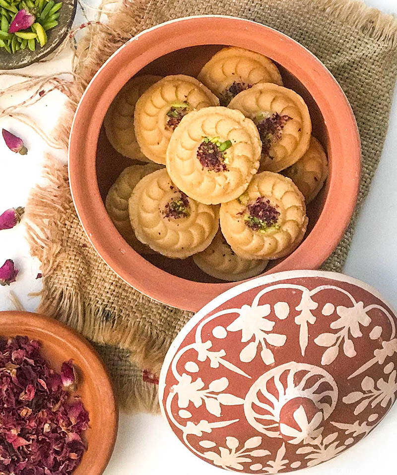A terra cotta jar full of rose flavoured ricotta cheese shondesh