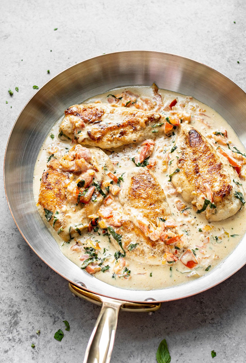 Creamy tomato basil chicken in a skillet