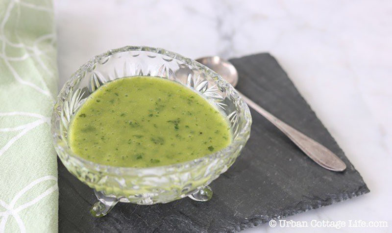 cut glass container of basil honey vinaigrette dressing