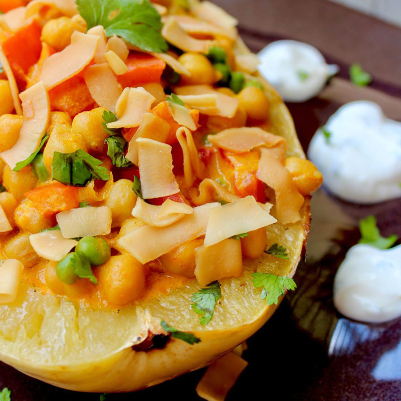 A spaghetti squash "bowl" with chickpeas in red curry sauce.