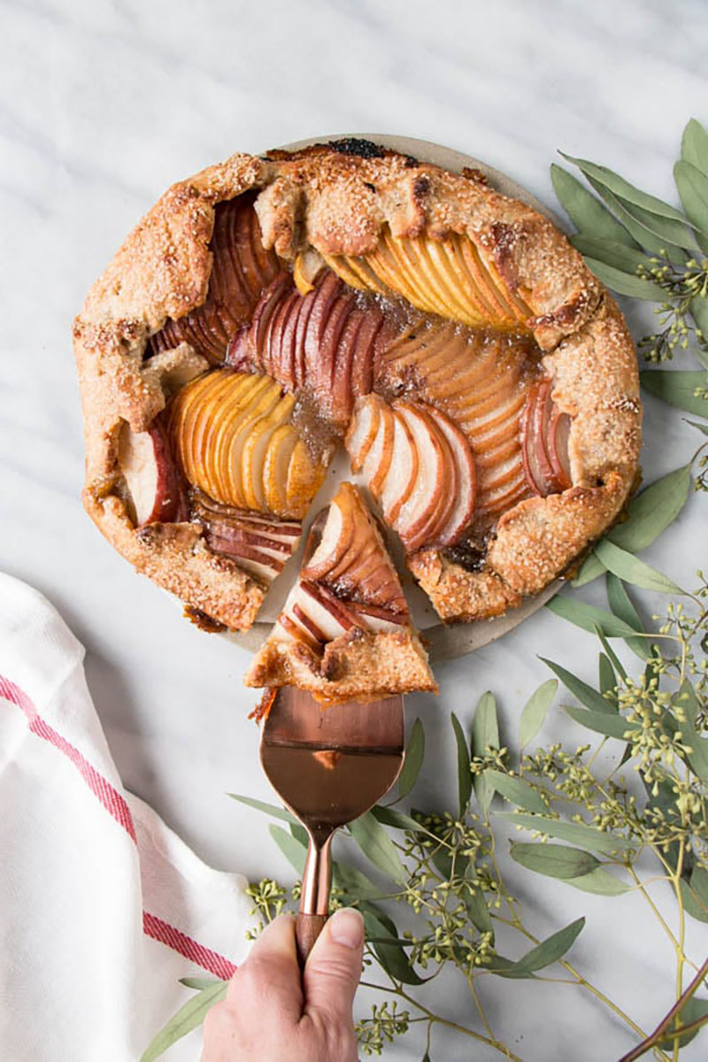 Cutting a slice out of a rustic pear galette