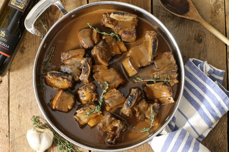 Stew pot full of red wine braised short ribs