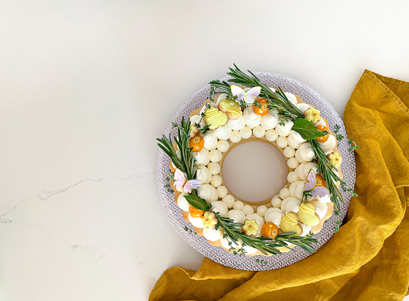 Cake decorated with rosemary and fruits