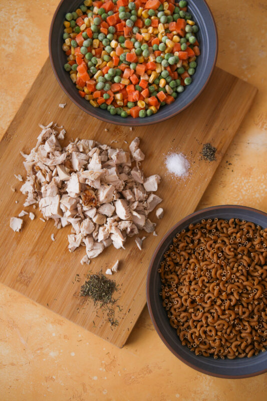 Pasta, chopped chicken, chopped carrots, peas.