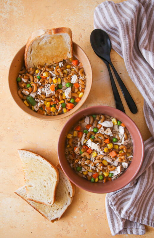 Chicken noodle soup in a bowl with bread