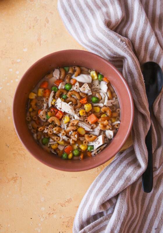 Chicken noodle soup with carrots, peas.
