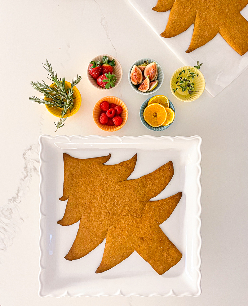 Cookie Christmas tree with lemon, raspberries, strawberries on the side.