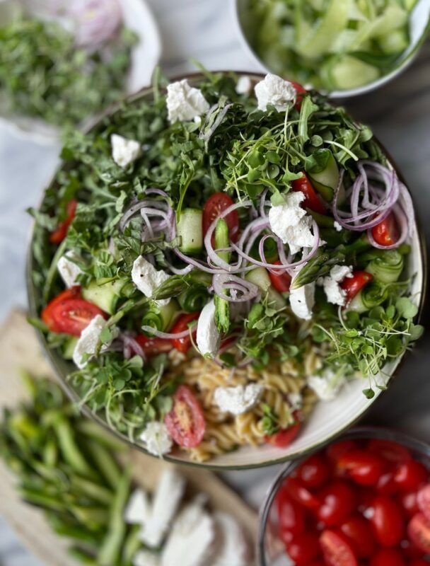 Lettuce, cheese, tomatoes, pasta salad.