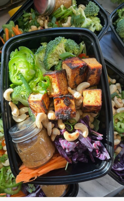 Salad, cashews, broccoli, red cabbage, homemade dressing