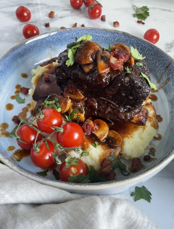 Braised beef with fresh tomatoes and mashed potatoes.