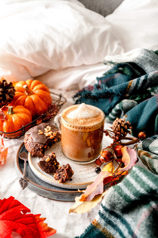 latte on a plate, orange pumpkins