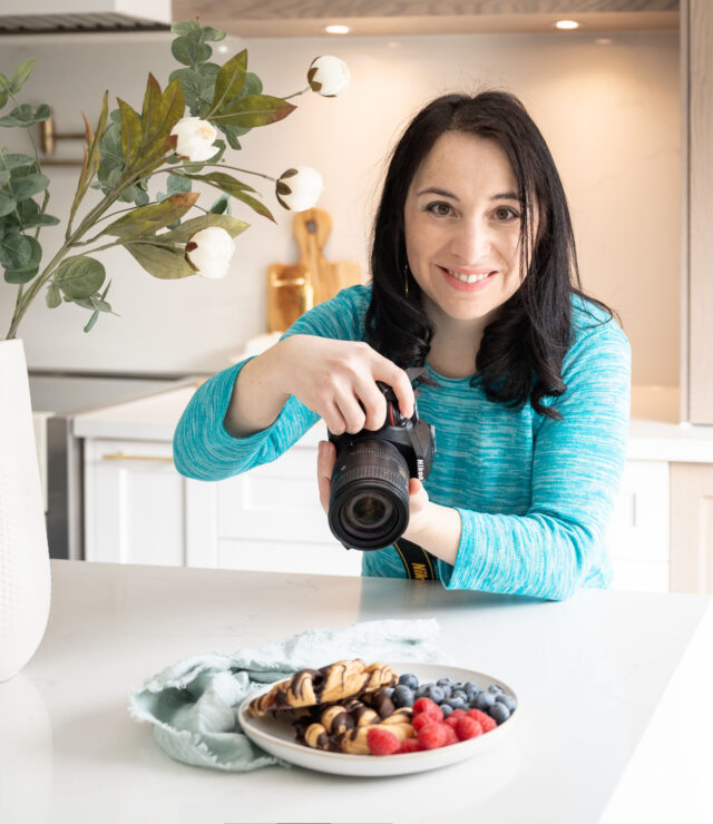 Person: Julia Konovalova with camera.