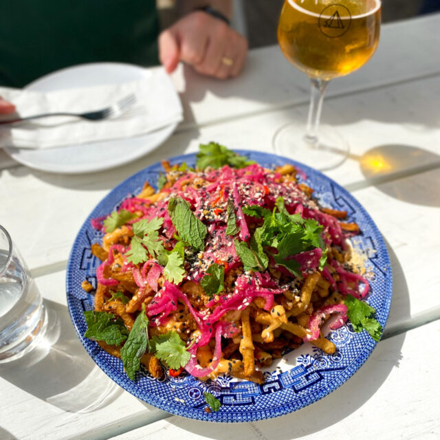 Fries on a plate with pickled red cabbage