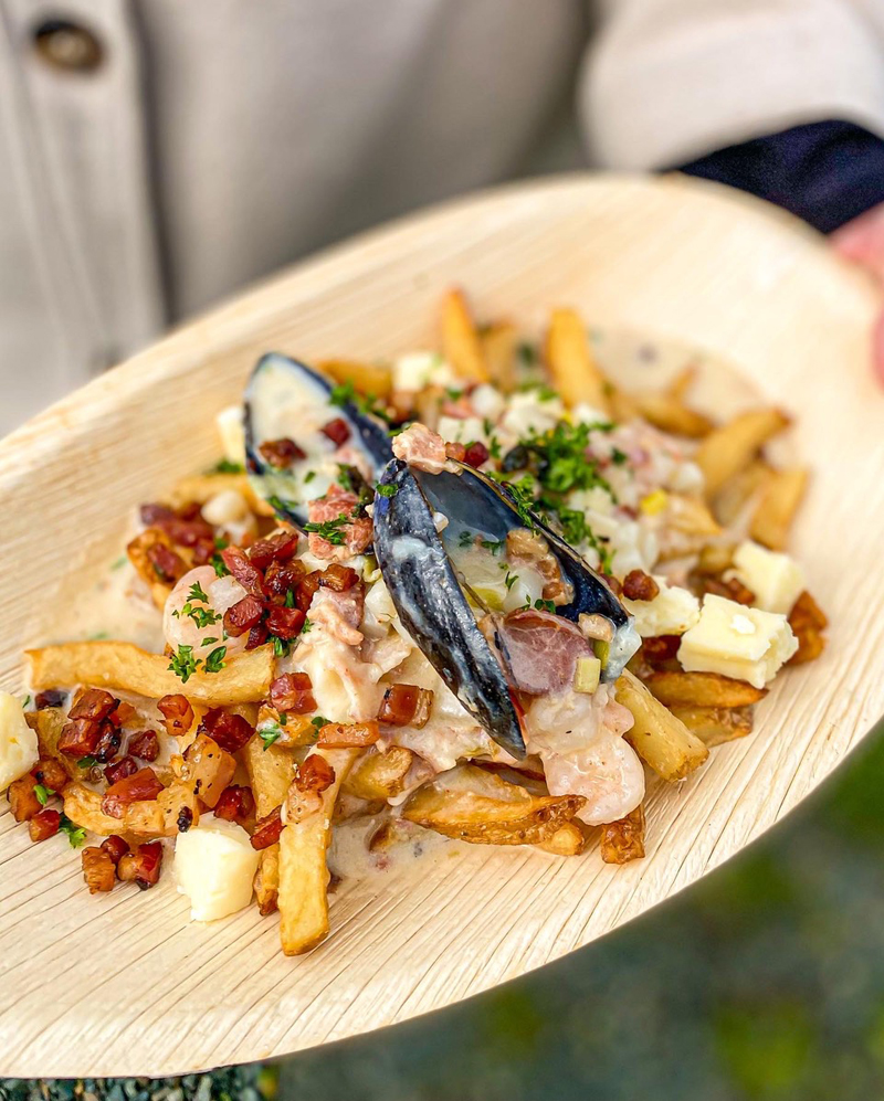 Fries on a plate with mussels and bacon