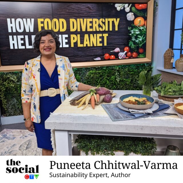 Puneeta Chhitwal-Varma in a blue dress standing by the table.