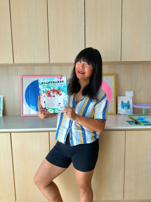 A person holding Plantcakes cookbook